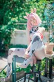 A woman in a cow costume sitting on a stool.