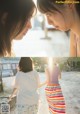 A couple of women standing next to each other on a beach.