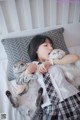 A woman laying on a bed with two cats.